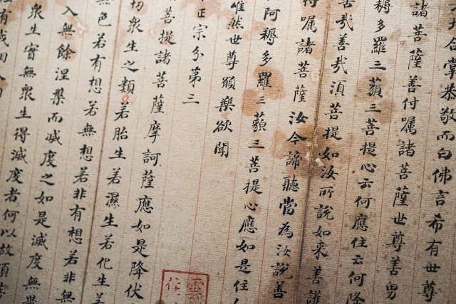 Ein alter kalligrafischer Text in chinesischer Sprache auf einer Seite mit einem offiziellen Stempel.