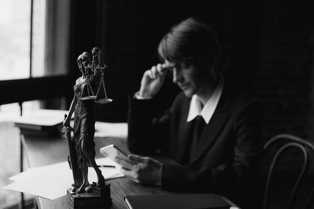 A photo of an attorney using a mobile phone in an office.