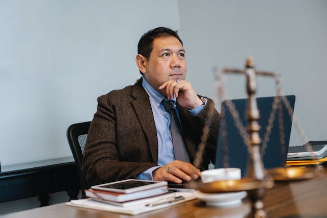 A picture of a judge working on a laptop in an office.