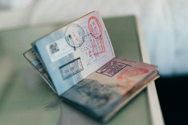 A picture of an open passport with stamped pages.
