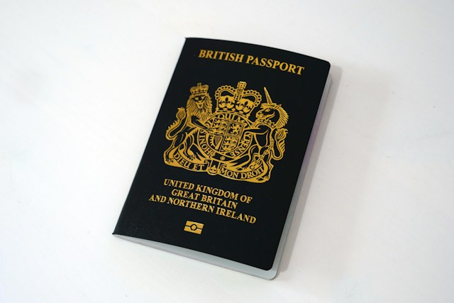 A British passport is on a white table.
