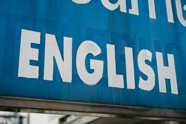 “English” written in white on a big blue billboard.
