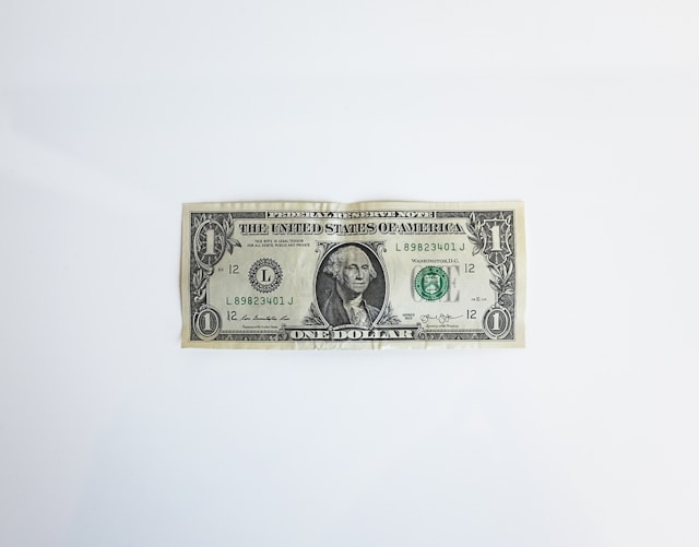 A dollar bill on a gray background.
