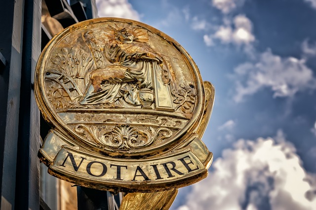 A wooden circular carved notary signpost. 
