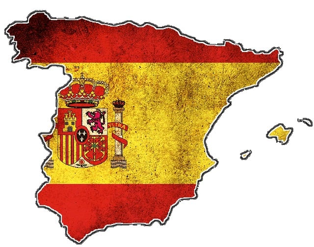 An illustration of the Spanish flag and emblem fixed on the map of Spain.