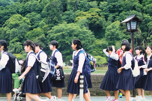 A group of high school students walk to school in Japan.
