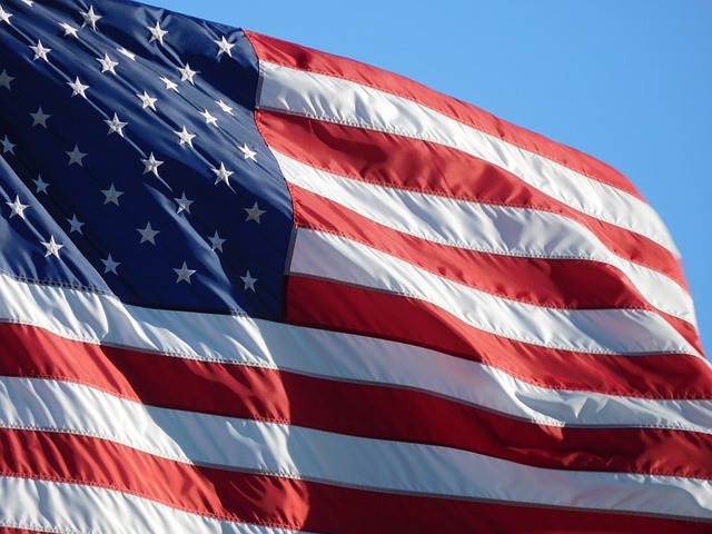 Close-up view of the American flag waving in the wind in day time.
