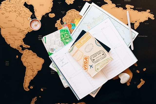 A visa, compass, and some documents on a world map.
