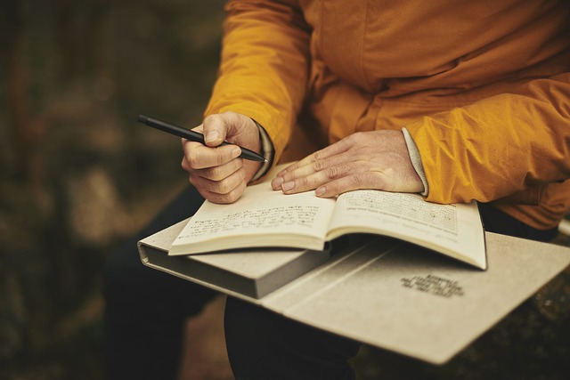 A person writes in a journal.
