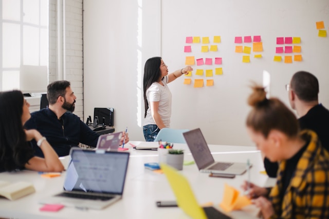 People in a boardroom work together on a translation task. 
