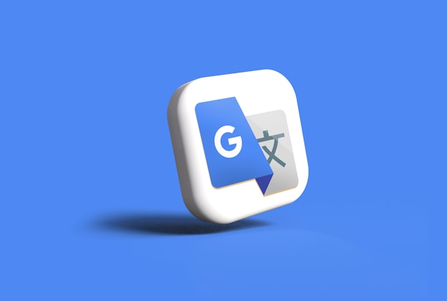 An image of Google Translate’s logo on a white cube on a blue background. 
