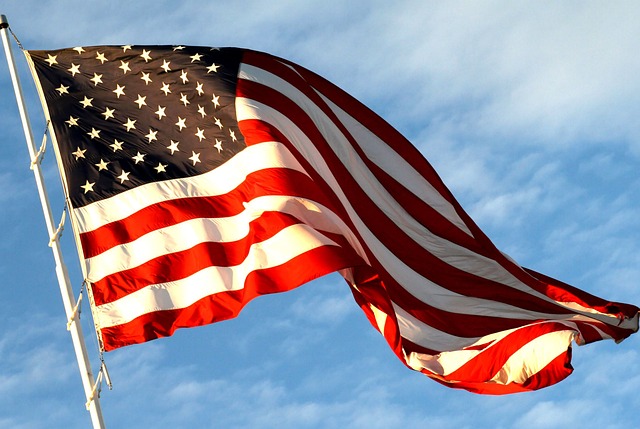 The U.S. flag flutters in the wind in the daytime.
