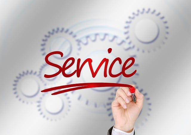 A hand writes “Service” with a red marker and white gear icons in the background.
