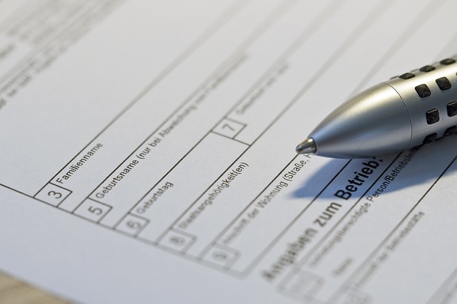 Close-up view of a silver pen on an empty form.