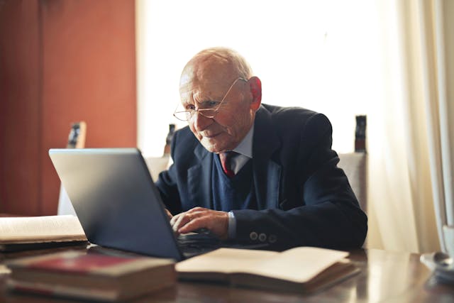 A person in a suit works on an office desk.