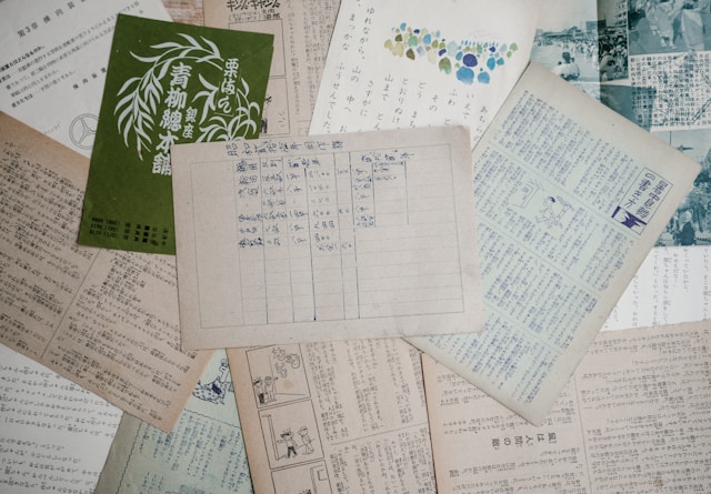 Several pieces of paper with handwritten text on them.
