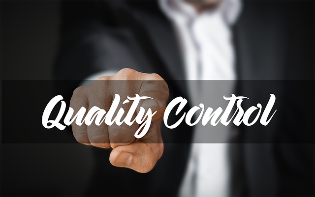 A person in a suit points at a floating “Quality Control” phrase.
