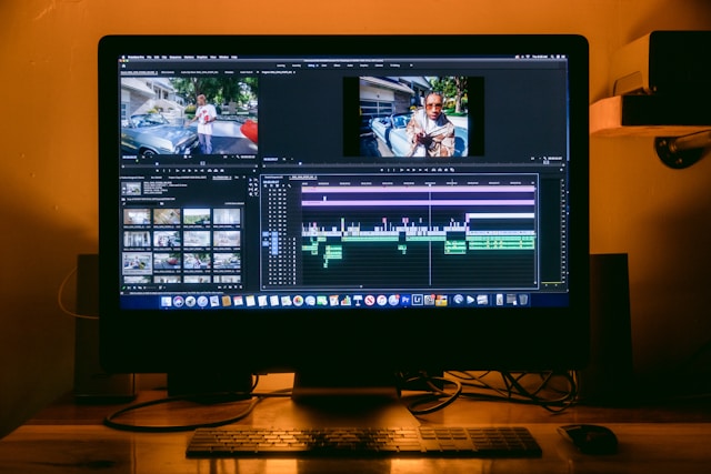 A computer setup for video editing on a desk.
