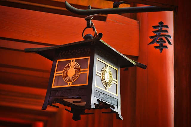 A brown Japanese lantern attached to a pillar containing a Japanese character.