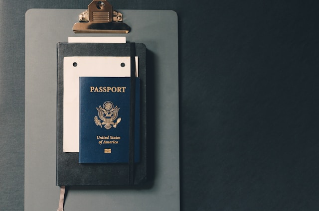 A U.S. passport booklet on another booklet on a table.
