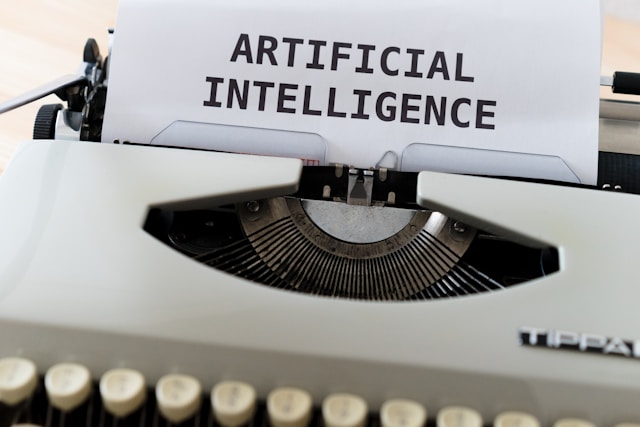 A typewriter prints out the words “ARTIFICIAL INTELLIGENCE.”
