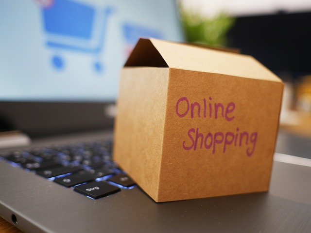 A brown box with the description “online shopping” on a black laptop keyboard.
