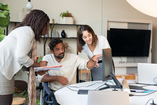 People work together on a translation at a translation agency. 
