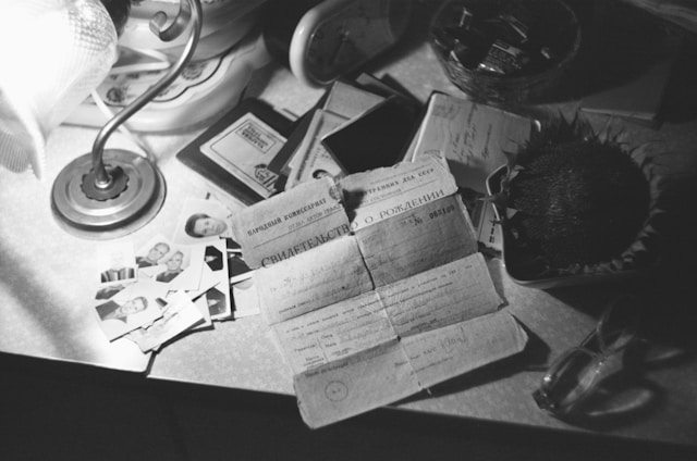 A person’s personal documents and birth certificate on a table.