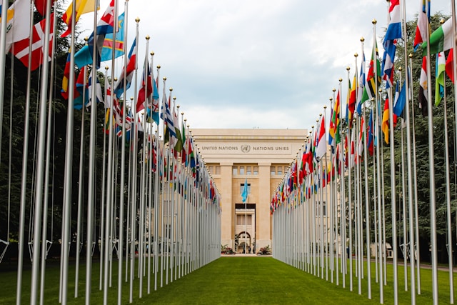 A United Nations building with flags in front of it.