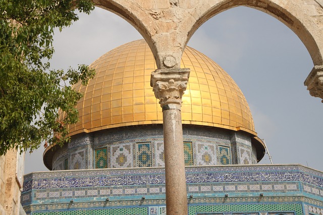 An Arab-style building with a gold roof in the daytime.