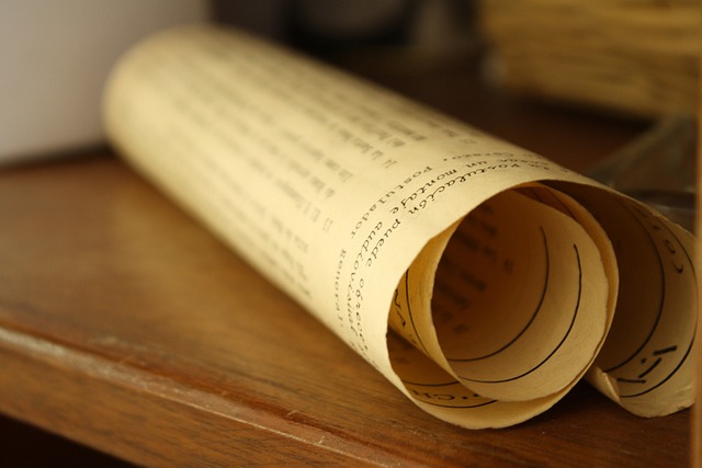 A brown rolled-up parchment paper on a wooden surface.
