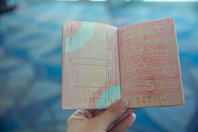 Someone holds a stamped passport.
