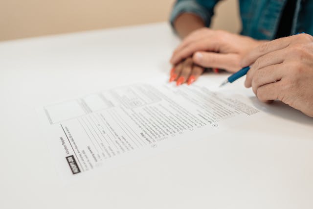 A couple signs an adoption request.
