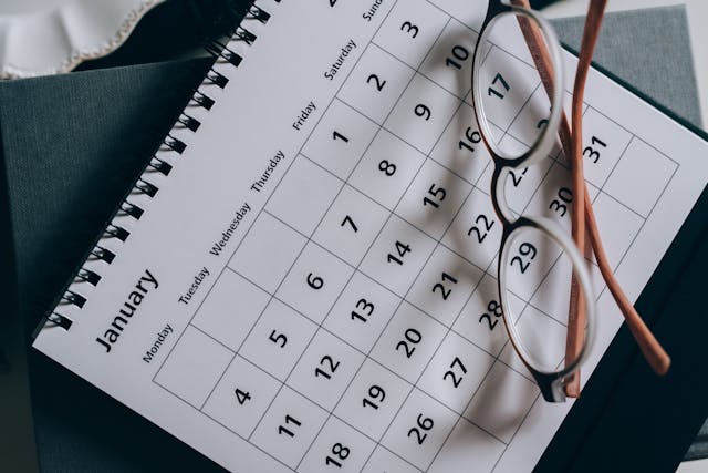 A pair of glasses on a calendar.
