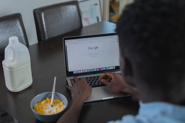 A person uses the Google Chrome app on a laptop.
