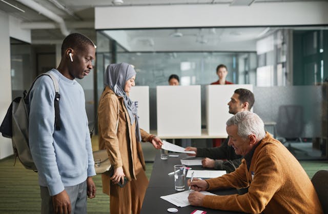 People submit documents to officials.
