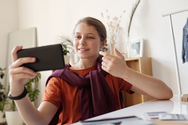 Someone uses a smartphone to partake in a video call.
