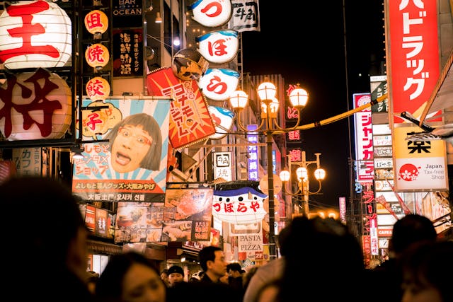 Several advertising signs on a busy street.