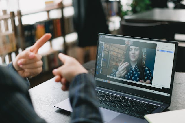 A person using sign language on a video call with someone else.